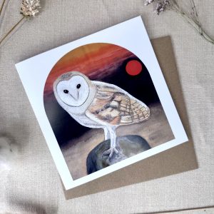 A printed card featuring an original hand-painted embroidered Barn Owl artwork at sunrise on a standing stone.