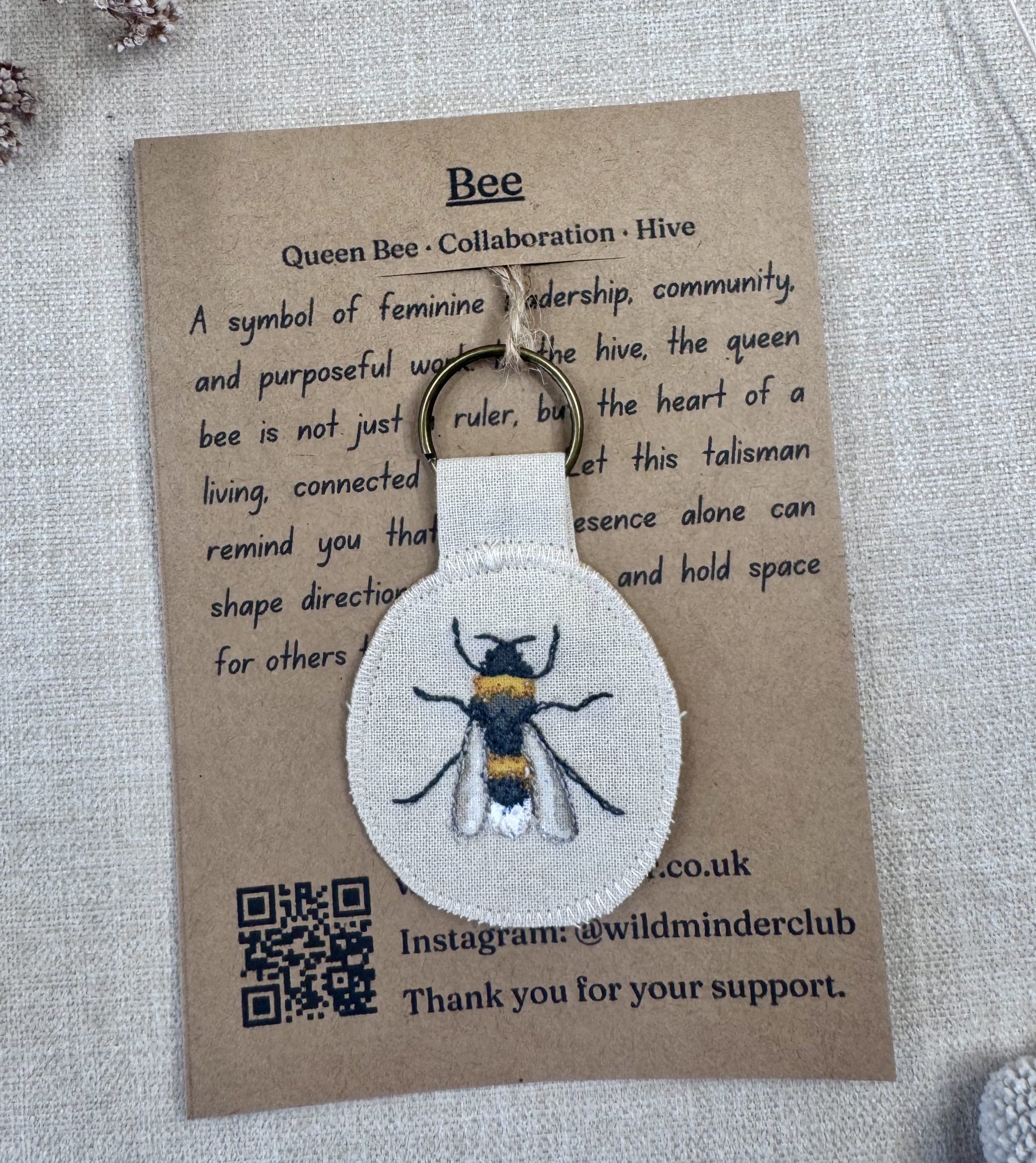 A photo of the Bee Talisman with backing card