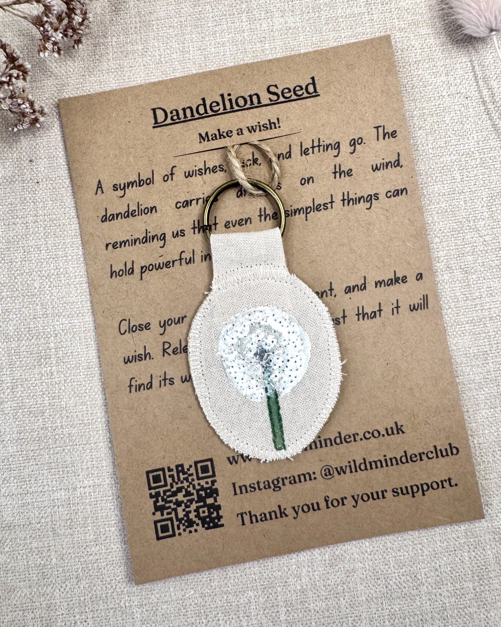 A photo of the Dandelion Seed Wish Talisman including its backing card